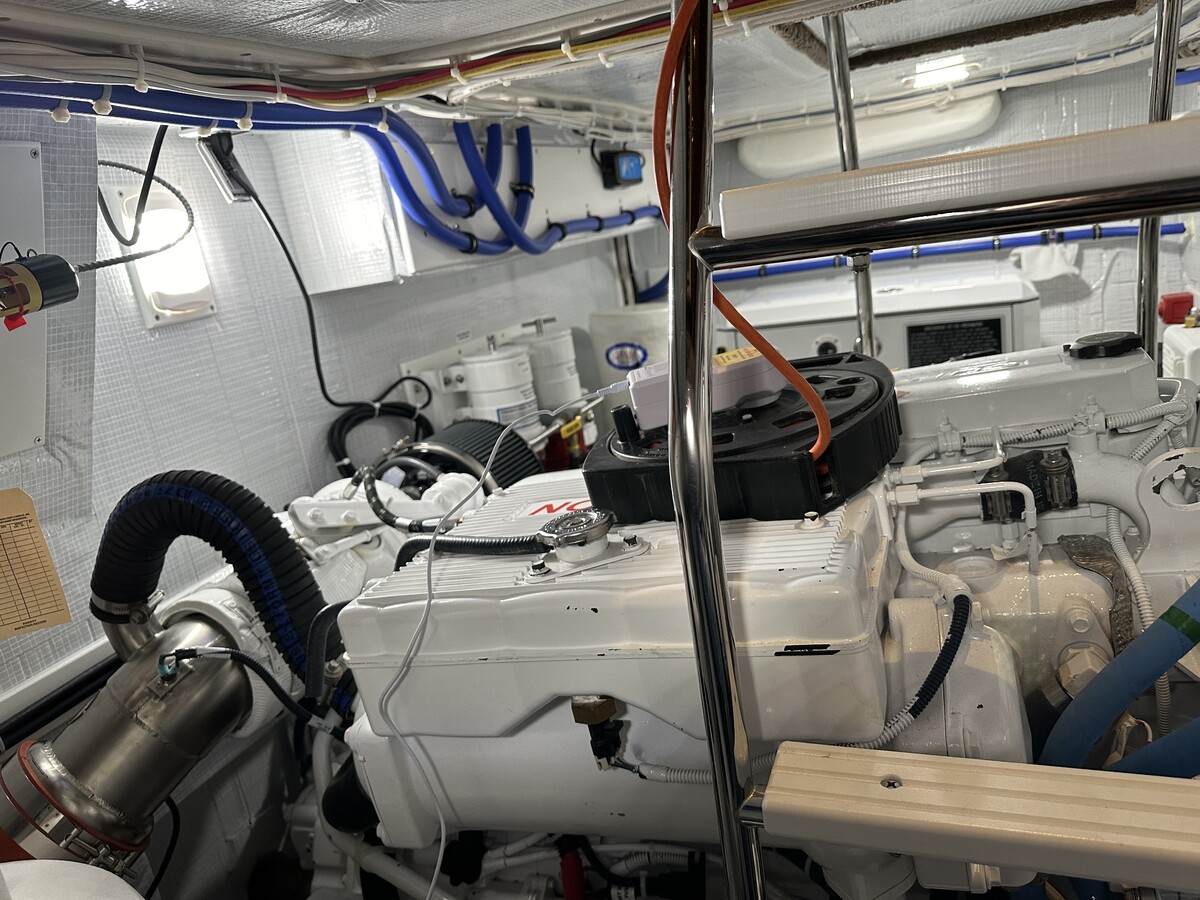 Close-up of an iSocket plugged into an extension cord in the boat’s engine room, used to monitor shore power and engine room temperature during winter storage.