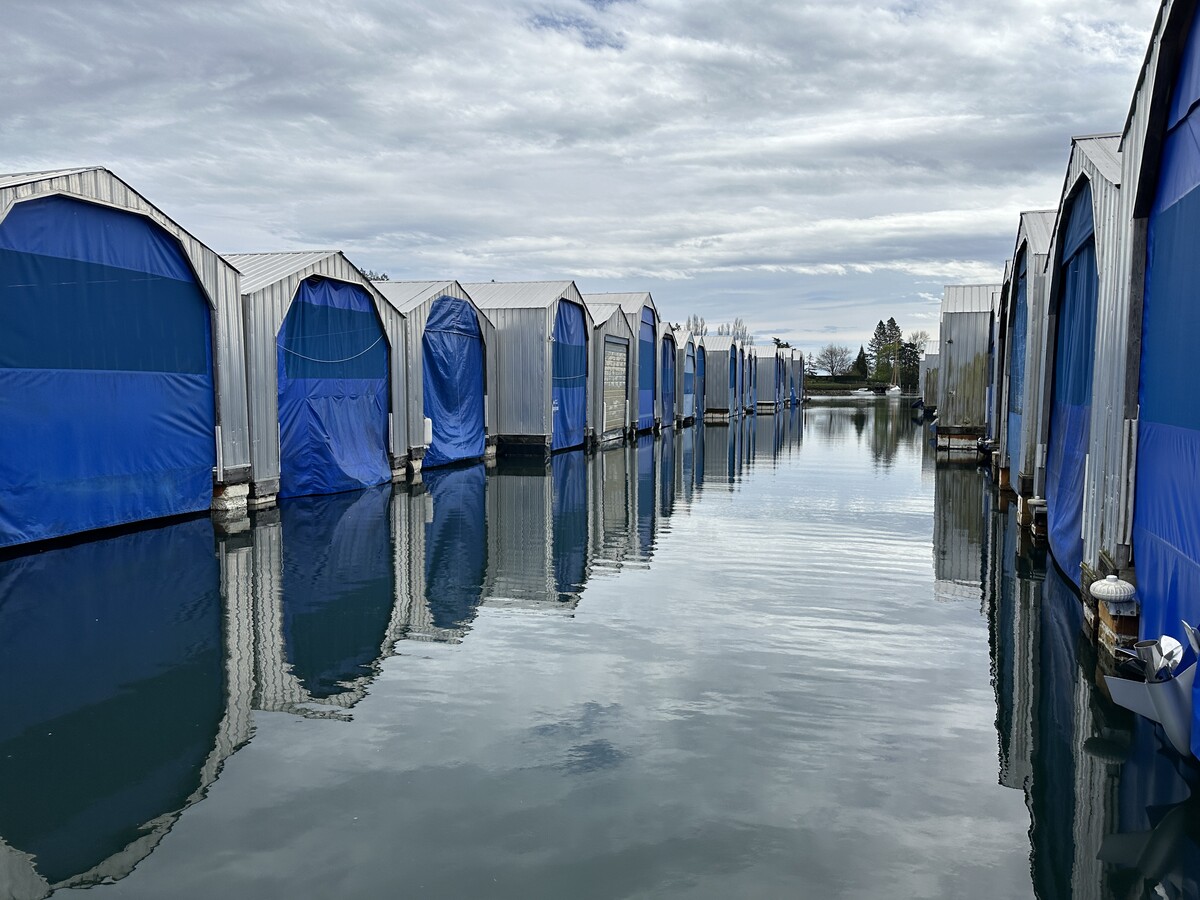 Quiet boathouses over calm water before winter, a good moment to test and fine-tune remote monitoring before leaving the boat for the season.